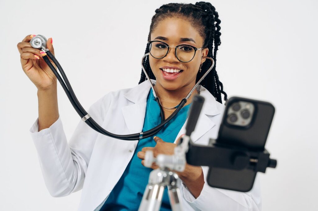 A doctor recording a short video on a phone mounted on a tripod