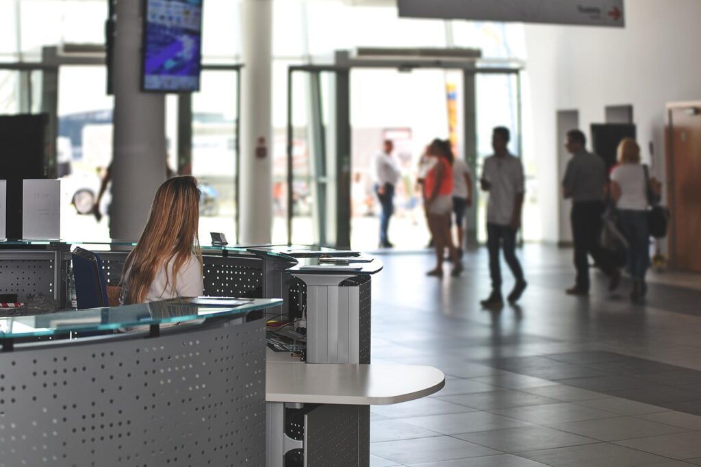 Reception desk of a modern clinic with a staff member at the counter
